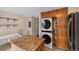 Laundry area has a stackable washer/dryer, storage cabinets, and adjacent kitchen island at 17151 E Stanford Ave # B, Aurora, CO 80015