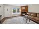 Comfortable living room with a fireplace, a cozy sofa, and hardwood floors, bathed in natural light at 17151 E Stanford Ave # B, Aurora, CO 80015
