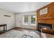 Living room with hardwood floors, bright window and a cozy fireplace with wooden mantel at 17151 E Stanford Ave # B, Aurora, CO 80015