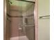 Bathroom features a tiled glass enclosed shower with a shower head and decorative trim at 17151 E Stanford Ave # B, Aurora, CO 80015