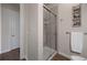 Modern bathroom featuring a glass-enclosed shower with tiled walls and wood flooring at 4336 Chateau Ridge Rd, Castle Rock, CO 80108