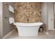 Elegant bathroom with a soaking tub set against decorative tile, complete with stylish fixtures and hardware at 4336 Chateau Ridge Rd, Castle Rock, CO 80108
