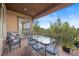 Cozy outdoor deck with seating, a table, and a peaceful view at 4336 Chateau Ridge Rd, Castle Rock, CO 80108