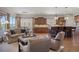 Living room seamlessly open to the kitchen with hardwood floors and natural light at 4336 Chateau Ridge Rd, Castle Rock, CO 80108