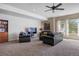 Spacious living room with plush seating, ceiling fan, and large windows at 4336 Chateau Ridge Rd, Castle Rock, CO 80108