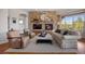 Cozy living room with a stone fireplace, wooden floors and comfortable seating at 4336 Chateau Ridge Rd, Castle Rock, CO 80108