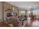 Inviting living room featuring a stone fireplace, hardwood floors and view at 4336 Chateau Ridge Rd, Castle Rock, CO 80108