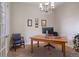 Home office with a large wooden desk, comfortable seating, and ample natural light from the windows at 4336 Chateau Ridge Rd, Castle Rock, CO 80108