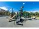 Neighborhood playground with slides, climbing structures and swings surrounded by trees and blue skies at 4336 Chateau Ridge Rd, Castle Rock, CO 80108