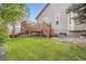 Well-maintained backyard with a wooden deck and lush green grass at 16179 W 70Th Pl, Arvada, CO 80007