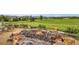 Backyard with a fire pit and scenic golf course views at 16179 W 70Th Pl, Arvada, CO 80007