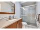 Modern bathroom with a glass-enclosed shower and stylish vanity at 16179 W 70Th Pl, Arvada, CO 80007