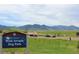Sign for West Arvada Dog Park with mountains visible in the background under a partly cloudy sky at 16179 W 70Th Pl, Arvada, CO 80007