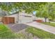 Traditional home showcasing an attached two-car garage, manicured lawn, and inviting front porch at 16179 W 70Th Pl, Arvada, CO 80007