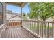 Inviting covered front porch with wood flooring, white railings, and stone pillars at 16179 W 70Th Pl, Arvada, CO 80007