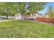 Charming home with a lush green lawn, a two-car garage and a quaint front porch at 16179 W 70Th Pl, Arvada, CO 80007