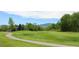 Scenic view of a well-manicured golf course with lush green grass and rolling hills at 16179 W 70Th Pl, Arvada, CO 80007