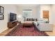 Comfortable living room featuring hardwood floors, a sectional sofa, and a large window at 16179 W 70Th Pl, Arvada, CO 80007