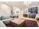 Inviting living room with an area rug, light-colored walls, and decorative cabinet at 16179 W 70Th Pl, Arvada, CO 80007