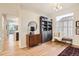 Inviting living room with an area rug, hardwood floors, and decorative cabinet at 16179 W 70Th Pl, Arvada, CO 80007