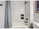White tiled shower with inset shelving and updated fixtures with gray stripped curtain at 1063 Roslyn Ct, Denver, CO 80230