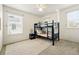 Bedroom featuring a bunk bed, side table, and a large window with blinds at 1063 Roslyn Ct, Denver, CO 80230