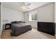 Cozy bedroom with natural light includes a dark dresser and side tables at 1063 Roslyn Ct, Denver, CO 80230