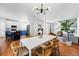 Open-concept living space that connects the kitchen, dining area, and living room with hardwood flooring at 1063 Roslyn Ct, Denver, CO 80230