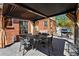 Covered patio with grill and outdoor seating perfect for relaxation at 1063 Roslyn Ct, Denver, CO 80230