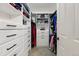 Walk-in closet with custom white shelving and ample storage space for clothes and accessories at 1063 Roslyn Ct, Denver, CO 80230