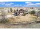 Aerial view of a home in a rural setting with a large yard and mature trees surrounded by pasture land at 28800 E 168Th Ave, Brighton, CO 80603