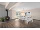 Open dining room with a wood burning stove, table seating for 10 and wood flooring at 28800 E 168Th Ave, Brighton, CO 80603