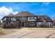 Beautiful two-story home with a brick exterior, white trim, a blue front door, and manicured landscaping at 28800 E 168Th Ave, Brighton, CO 80603