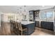 Open kitchen with a large island, pendant lighting, stainless steel appliances, and hardwood floors at 28800 E 168Th Ave, Brighton, CO 80603