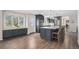 Modern kitchen features gray cabinets, stainless appliances, large island, and wood flooring with natural light at 28800 E 168Th Ave, Brighton, CO 80603