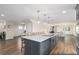 Bright kitchen features large island, pendant lighting, and flows into dining area with wood burning stove at 28800 E 168Th Ave, Brighton, CO 80603