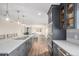 Modern kitchen features gray cabinetry, a large island with seating, stainless steel appliances, and pendant lighting at 28800 E 168Th Ave, Brighton, CO 80603