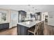 Spacious kitchen boasts a large island with seating, pendant lights, stainless appliances and a back door at 28800 E 168Th Ave, Brighton, CO 80603