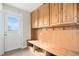 Bright mudroom features built-in cabinets and wooden bench with hooks, adjacent to the door at 28800 E 168Th Ave, Brighton, CO 80603