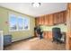 Multi-purpose laundry room with built-in office area, cabinets, and natural light at 28800 E 168Th Ave, Brighton, CO 80603