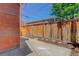 The back yard has a concrete patio, a wooden fence, and fresh mulch at 729 E 10Th Ave, Denver, CO 80203