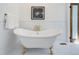 Charming bathroom with a clawfoot tub, complemented by elegant gold fixtures and classic white tile at 729 E 10Th Ave, Denver, CO 80203