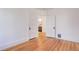 Bright, freshly painted bedroom with pristine hardwood floors, doors leading to a bathroom at 729 E 10Th Ave, Denver, CO 80203