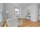 Bright bedroom featuring modern decorations, hardwood floors, and a sitting area with comfortable chairs at 729 E 10Th Ave, Denver, CO 80203
