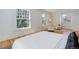Bright bedroom featuring large windows, a sitting area, and a comfortable bed at 729 E 10Th Ave, Denver, CO 80203