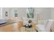 Bright bedroom with comfortable chairs and plentiful light from multiple windows at 729 E 10Th Ave, Denver, CO 80203