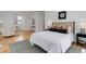 Well-lit bedroom features a comfortable bed, sitting area, modern art, and hardwood floors at 729 E 10Th Ave, Denver, CO 80203