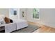 Comfortable bedroom with hardwood floors, a neutral rug, and natural light from a window at 729 E 10Th Ave, Denver, CO 80203