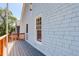 Charming home exterior featuring light blue shake siding, a spacious wooden deck, and window at 729 E 10Th Ave, Denver, CO 80203