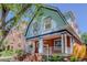 Charming two-story home featuring a brick facade, inviting front porch, and architectural details at 729 E 10Th Ave, Denver, CO 80203